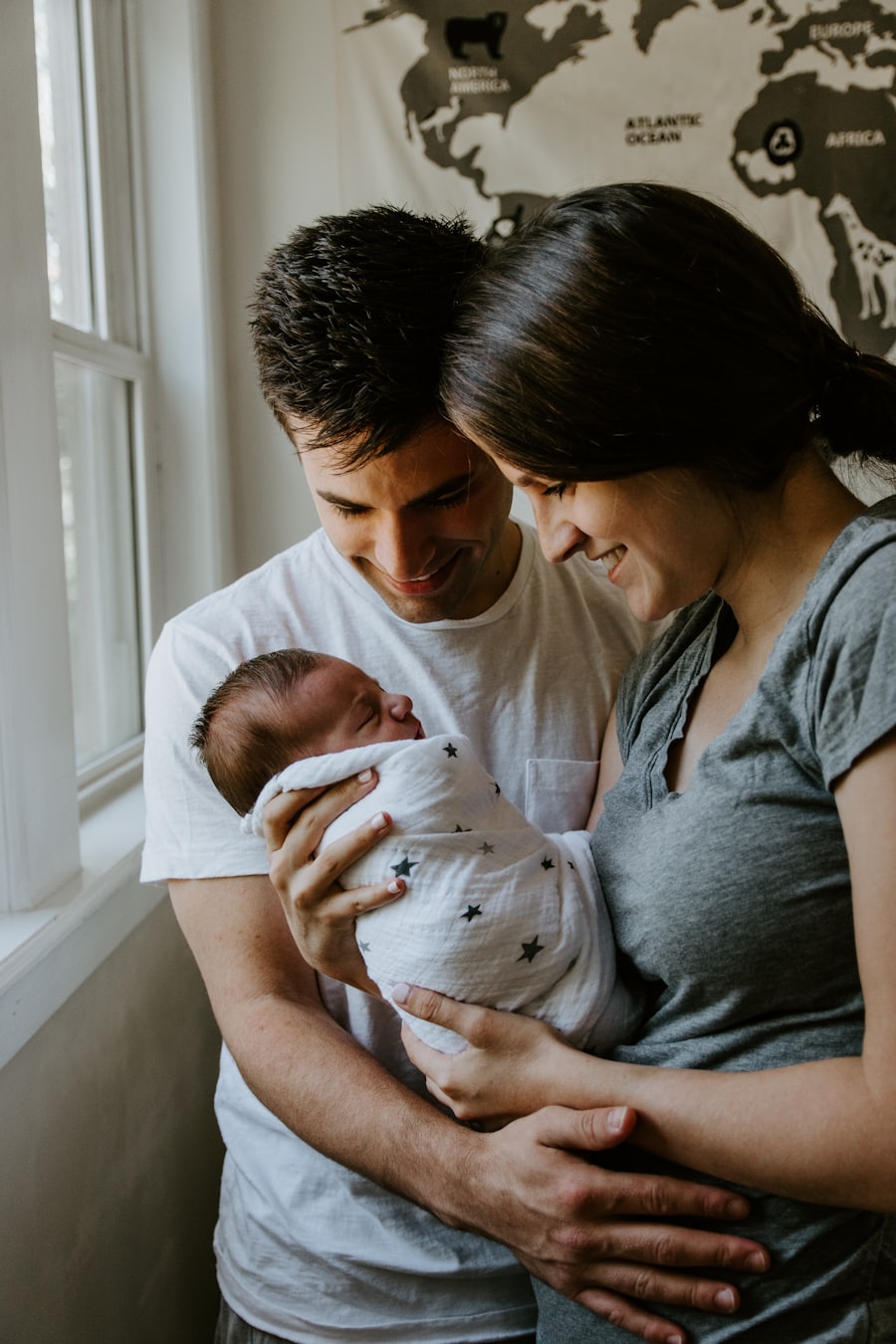 New parents holding their newborn child